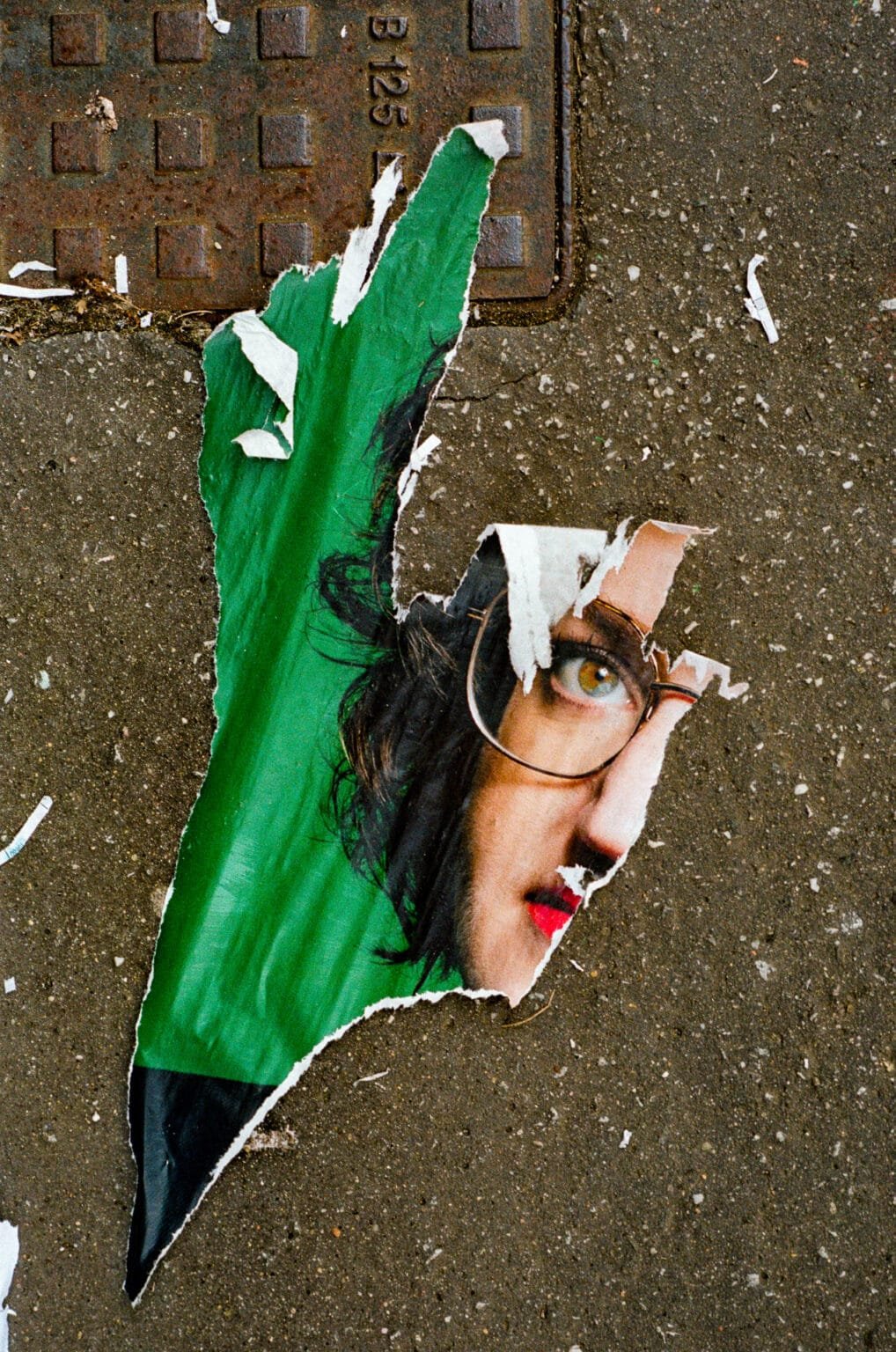 Affiche déchirée de Marie Toussaint sur un trottoir à Nantes, en juin 2024.