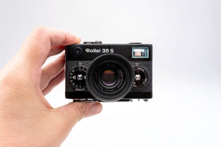 Le Rollei 35 S tenu en main, illustrant sa taille compacte et son objectif Sonnar 40mm f/2.8 déployé.
