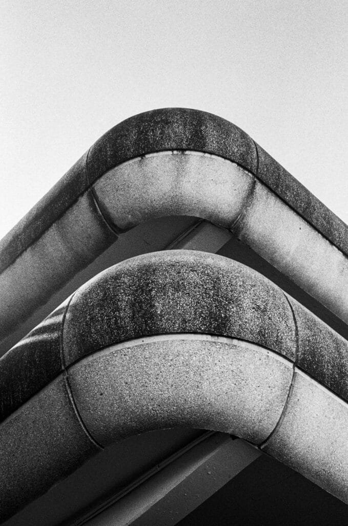 Détail architectural en gros plan du parking de la gare de Nantes, photographié en noir et blanc avec une forte texture et des formes courbes.