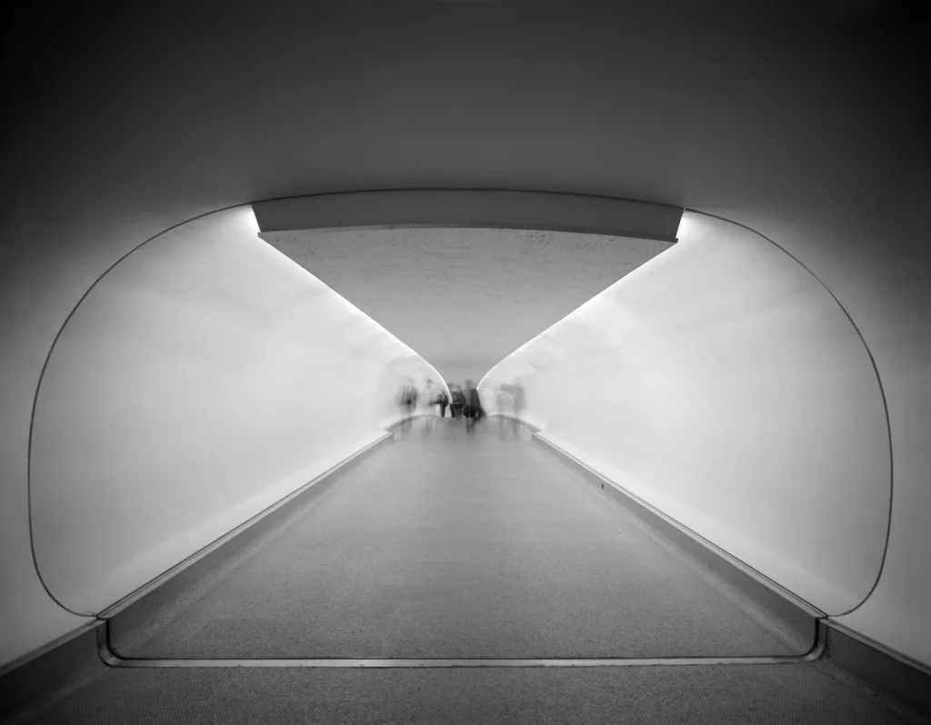 Couloir incurvé du TWA Flight Center à New York photographié en 1962 par Ezra Stoller, architecture fluide et lumière rasante d’Eero Saarinen.