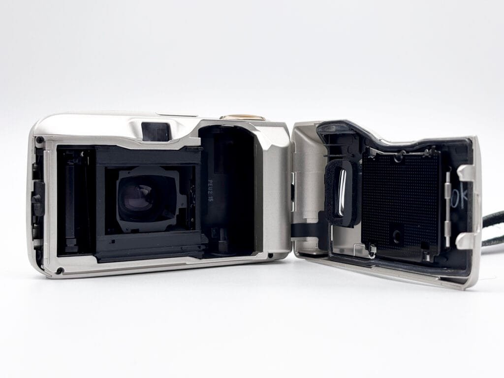 Olympus Mju II avec trappe arrière ouverte montrant la chambre film et le logement de la pellicule.